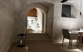 A stylish room with a staircase and lanterns.