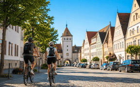 A group of cyclists ride through the historic old town of Oettingen